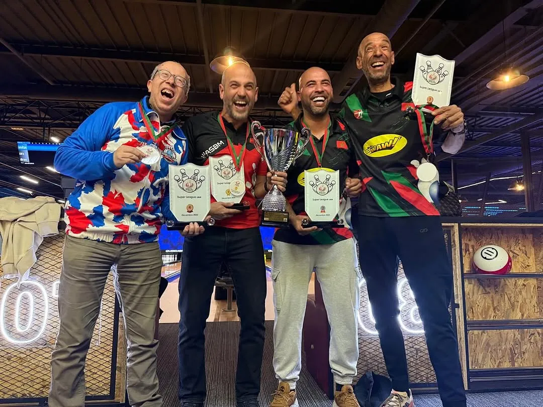 Four bowlers holding up trophies and medals after a bowling competition in Casablanca