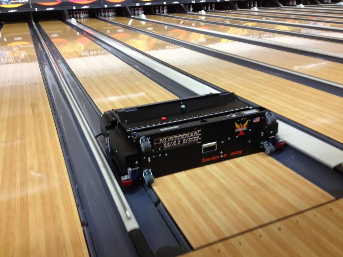 Automatic lane machine sitting on a bowling lane to apply conditioner